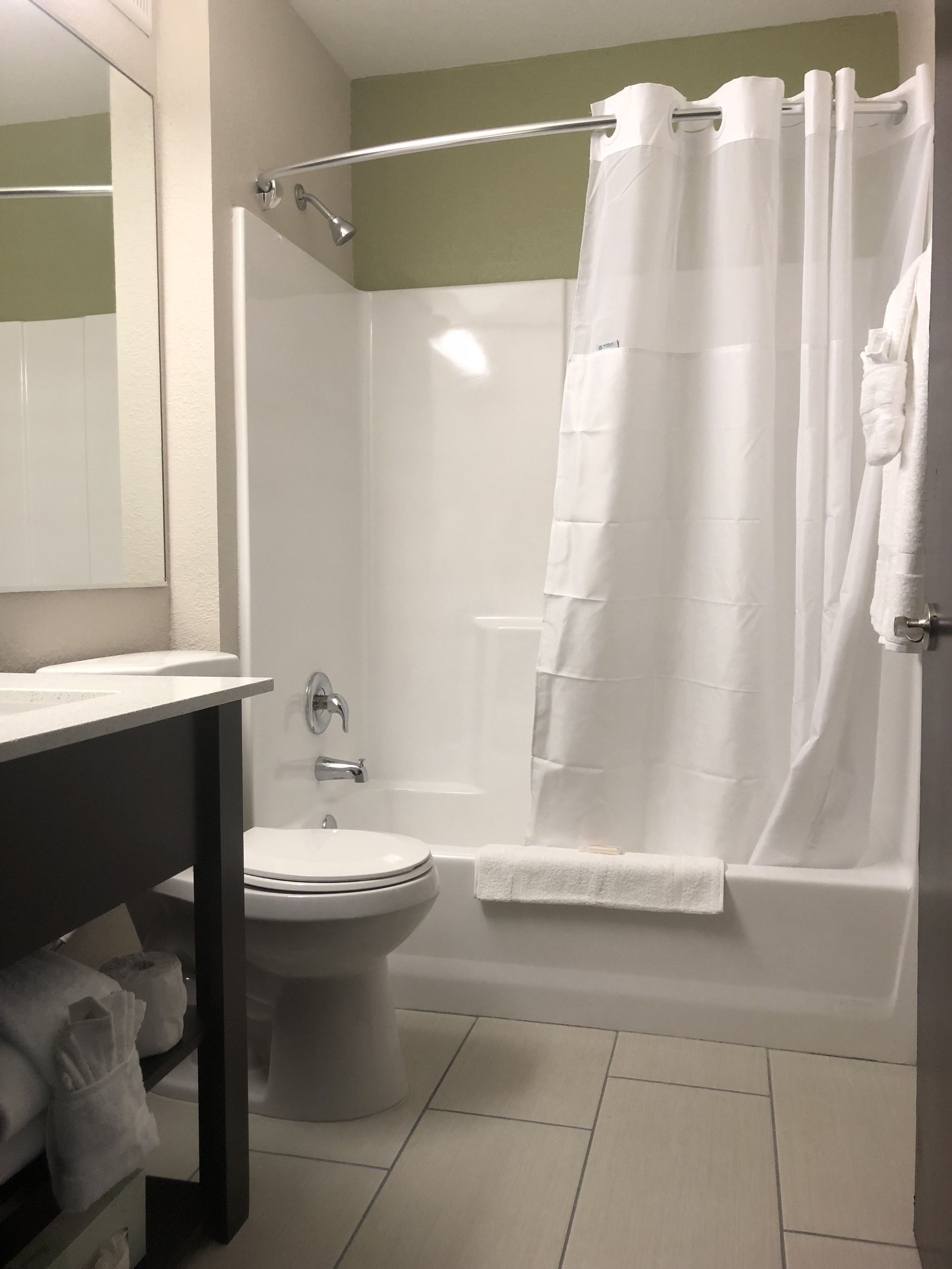 A bathroom with a toilet, sink, and shower.