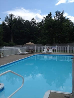 Seasonal outdoor pool, open 9:00 AM to 10:00 PM, pool umbrellas