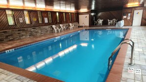 An indoor swimming pool with a wooden wall and tiled floor. - MainStay Suites LeClaire - Quad Cities (Le Claire)