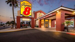 A Super 8 hotel with a prominent sign, a covered parking area, and a well-lit entrance. - Super 8 by Wyndham Marana/Tucson Area (Tucson)