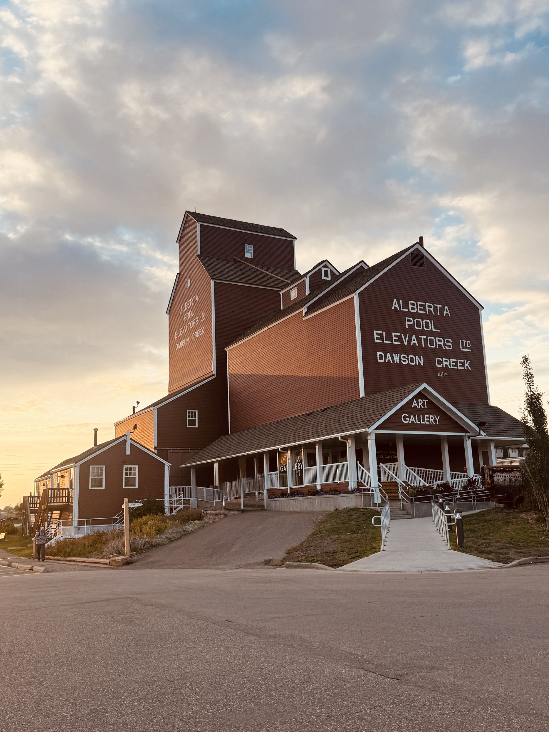 A building with a prominent sign for Alberta Pool Elevators LTD and Dawson Creek Art Gallery.