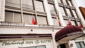 A hotel named 'Peterborough Inn & Suites' with a classic facade, large windows, and a prominent awning. - Peterborough Inn & Suites Hotel (Peterborough)
