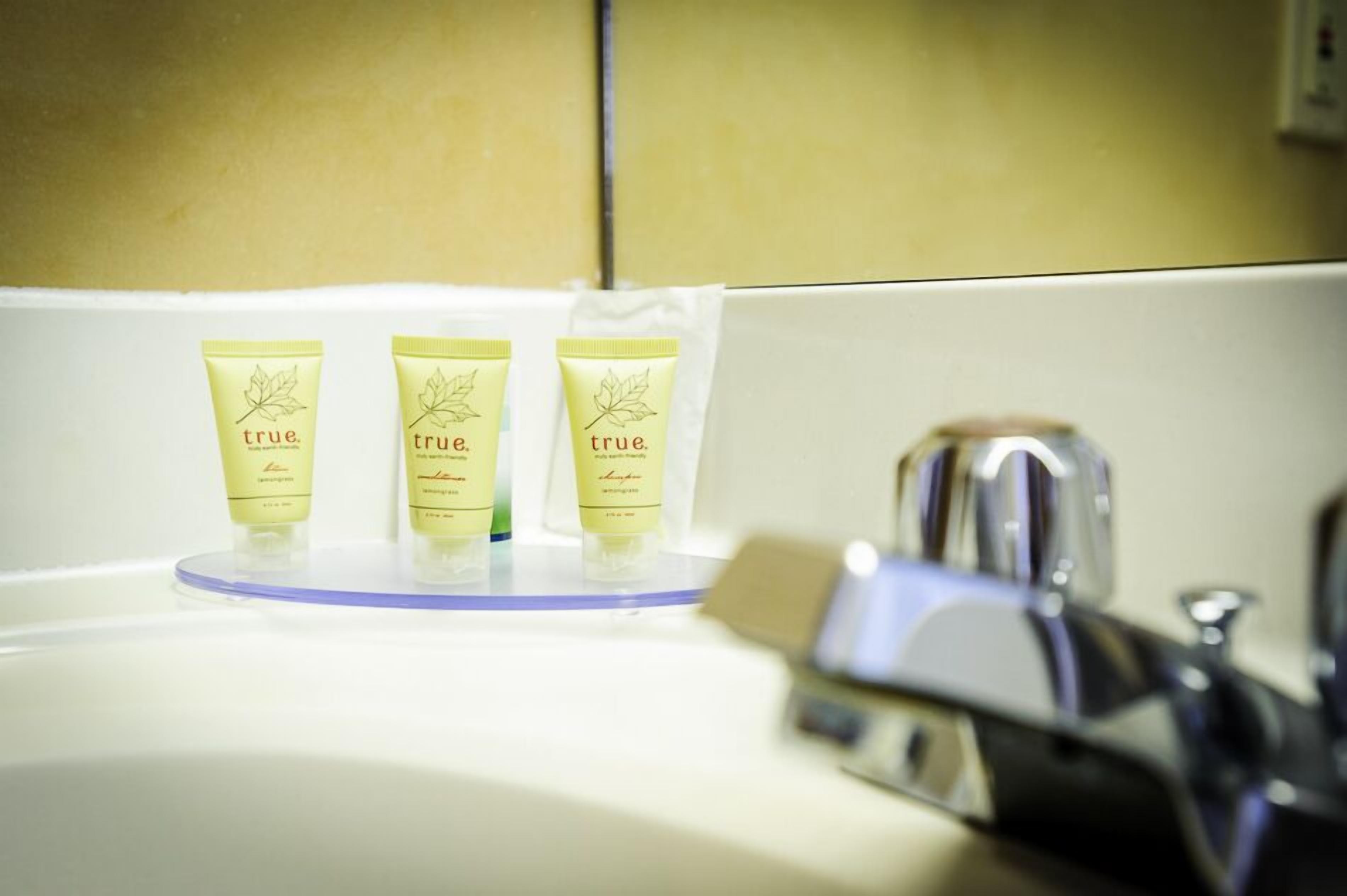 Three tubes of 'true' shampoo on a bathroom sink.