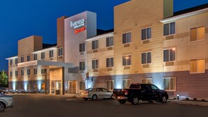A multi-story hotel with a prominent sign for Fairfield Inn & Suites by Marriott.