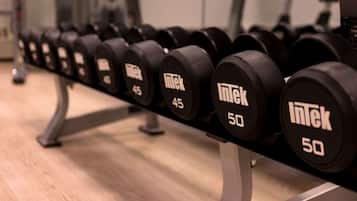 A row of dumbbells labeled with weights ranging from 45 to 50 kilograms.