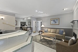 Hot Tub Suite | Living area | 65-inch flat-screen TV with cable channels
