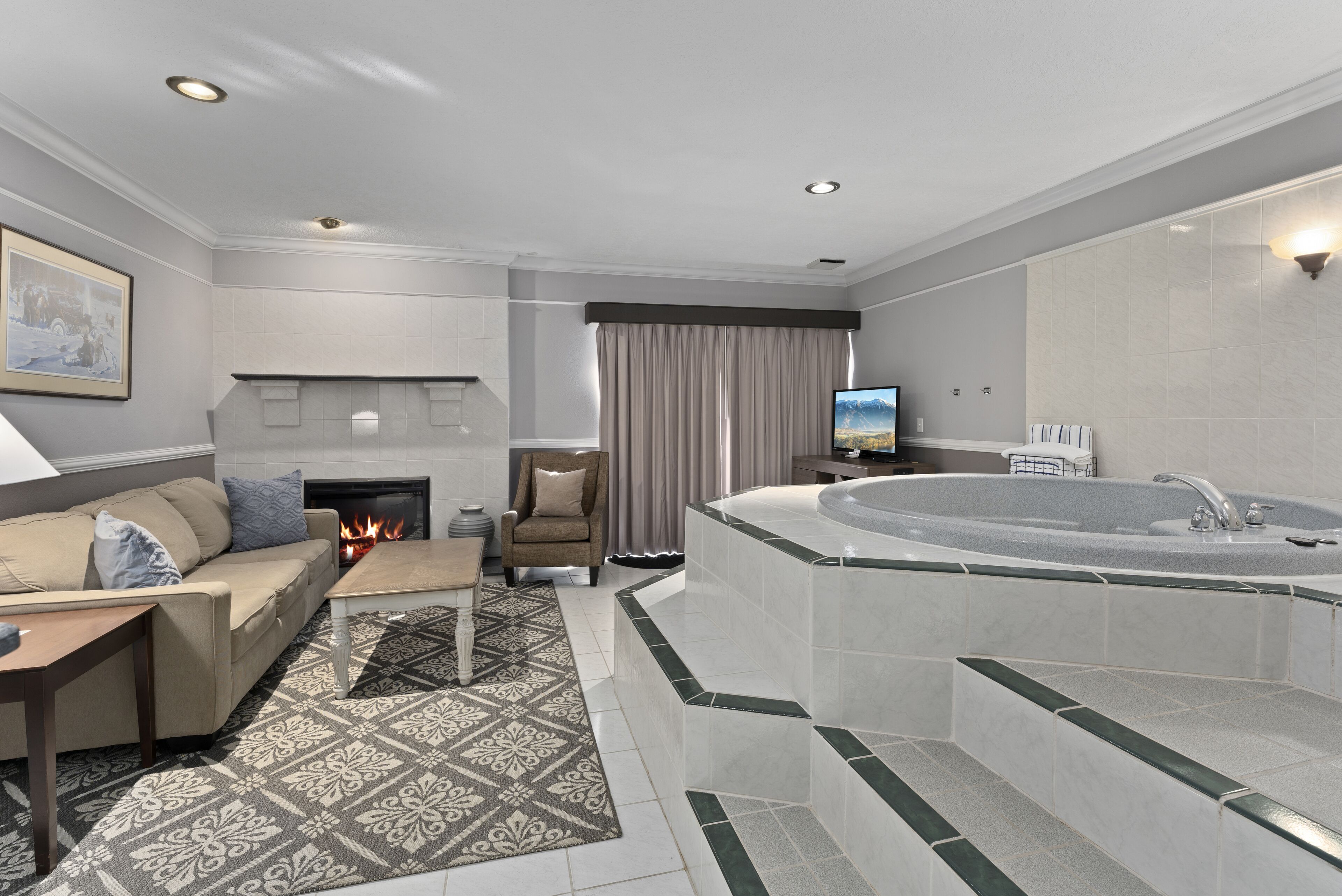 Hot Tub Suite | Living area | 65-inch flat-screen TV with cable channels