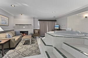 Hot Tub Suite | Living area | 65-inch flat-screen TV with cable channels
