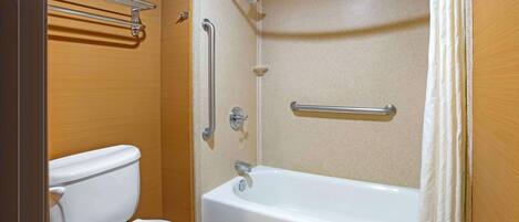 A bathroom with a toilet, a bathtub, and a shower.