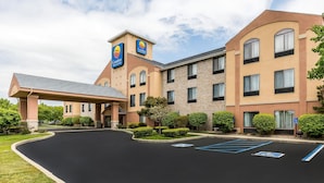 A Comfort Inn hotel with a covered entrance, multiple floors, and a parking lot with handicapped spaces.