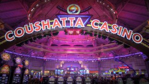 A casino interior with a prominent sign reading "COUSHATTA CASINO" and multiple slot machines. - Inn at Coushatta (Kinder)