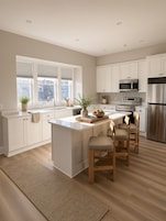 Una cocina moderna con armarios blancos, una isla central con asientos, electrodomésticos de acero inoxidable y un amplio ventanal que proporciona luz natural.