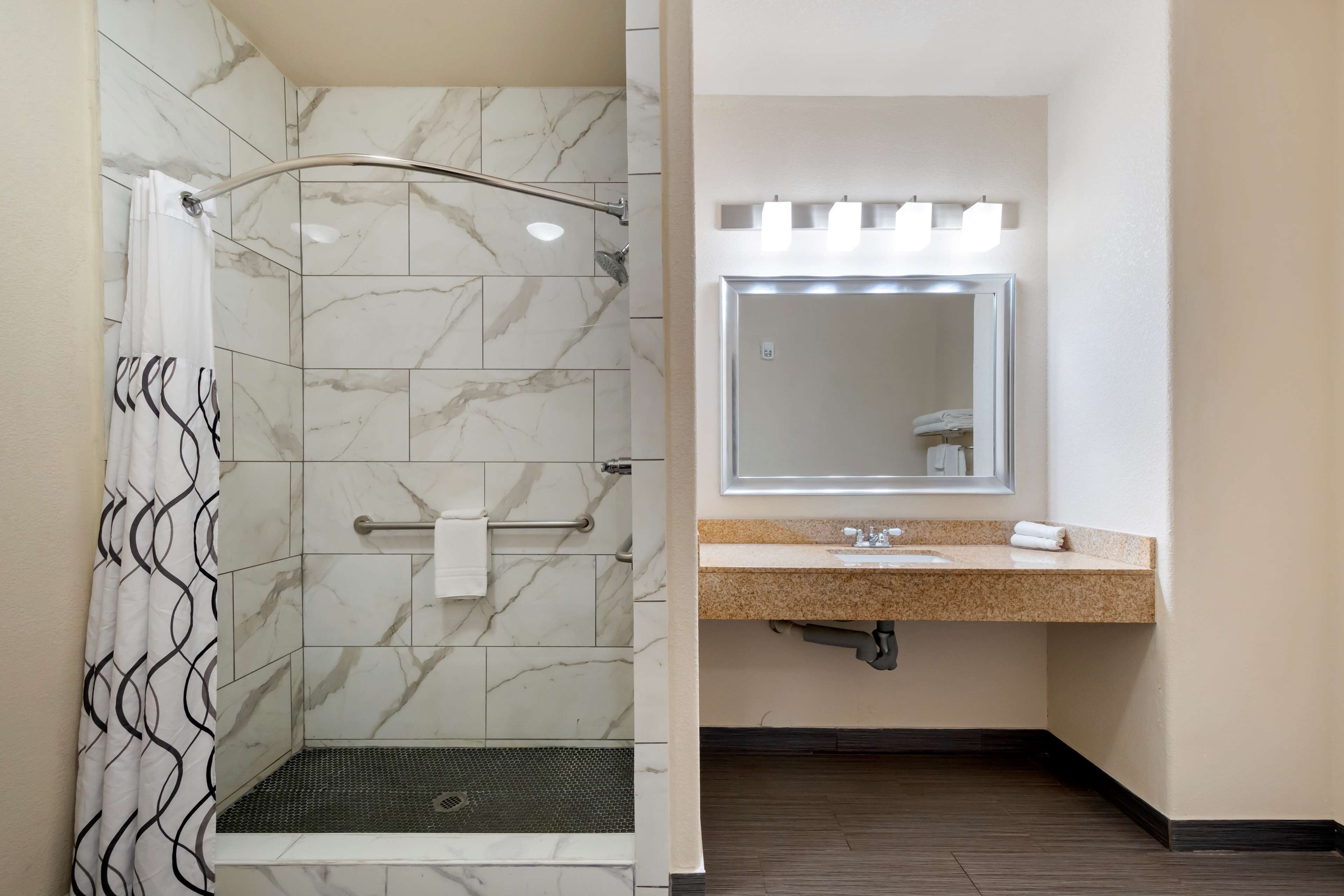 suite, 1 king bed, non smoking, refrigerator & microwave (living room;with sofabed) | bathroom | combined shower/bathtub, free toiletries, hair dryer, towels