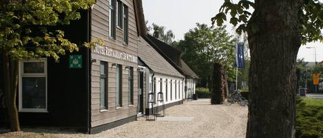 A building with a sign indicating it is a hotel and restaurant.