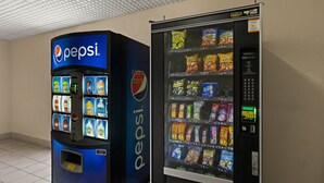 A vending machine with Pepsi branding and a selection of snacks.