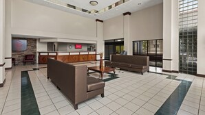 A spacious lobby with a reception desk, seating area, and a large window providing natural light. - Red Roof Inn & Suites Newnan (Newnan)