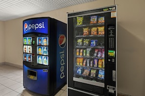 A vending machine with a Pepsi logo and a selection of snacks. - Red Roof Inn & Suites Newnan (Newnan)
