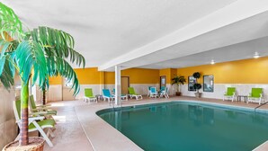 An indoor swimming pool with lounge chairs and potted plants. - Quality Inn Litchfield Route 66 (Litchfield)