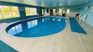 An indoor swimming pool with clear blue water, surrounded by tiled flooring and walls. - Holiday Inn Express Bluffton by IHG (Bluffton)