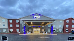A Holiday Inn Express hotel with a covered entrance, stone pillars, and a blue-lit sign. - Holiday Inn Express Bluffton by IHG (Bluffton)