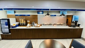 A breakfast bar with labeled dispensers for yogurt, eggs, milk, fruit, and cereal. - Holiday Inn Express Bluffton by IHG (Bluffton)