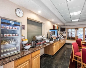 Enjoy a hearty breakfast at our hotel's breakfast area, where a self-service counter offers a variety of food and beverages.
