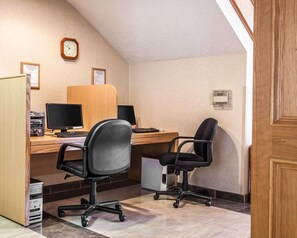 Work comfortably with two desks, a computer, and a chair in this functional office space.