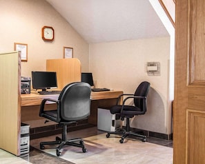 Work comfortably with two desks, a computer, and a chair in this functional office space.