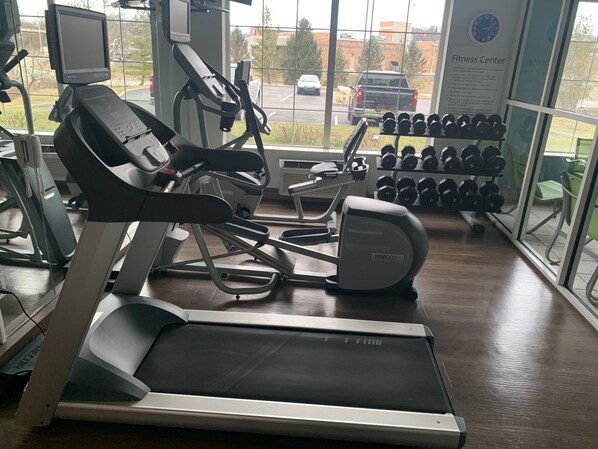 A gym with treadmills, a stationary bike, and a rack of dumbbells. - Holiday Inn Express Pittsburgh-Bridgeville by IHG (Bridgeville)