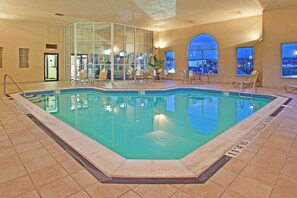 An indoor swimming pool with clear water, surrounded by lounge chairs and a glass wall. - Holiday Inn Express Pittsburgh-Bridgeville by IHG (Bridgeville)
