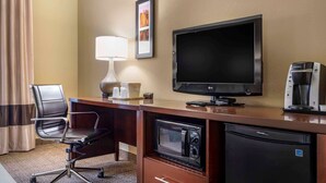 A hotel room with a desk, a television, a coffee maker, a microwave, and a refrigerator. - Comfort Inn Duncansville - Altoona (Hollidaysburg)