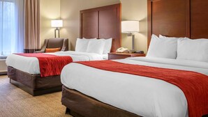 A hotel room with two beds, a chair, a desk with a lamp, and a telephone. - Comfort Inn Duncansville - Altoona (Hollidaysburg)