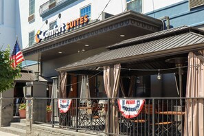 Comfort Suites features a classic exterior with a prominent sign and balcony.