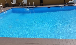 Seasonal outdoor pool, open 9:00 AM to 9:00 PM, pool umbrellas