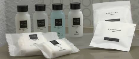 A collection of skincare products from the Beekman brand, including a facial bar, lotion, and a remover wipe.