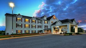 A multi-story hotel with a prominent entrance and a parking area.