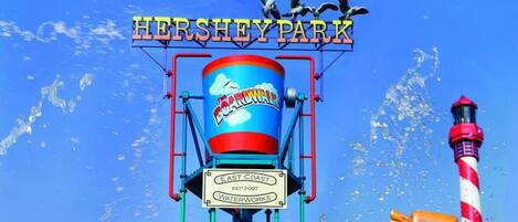 A water park with a sign reading 'Hershey Park' and a water slide.