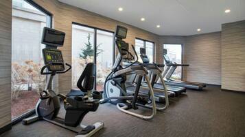 A fitness center with treadmills, elliptical machines, and stationary bikes.