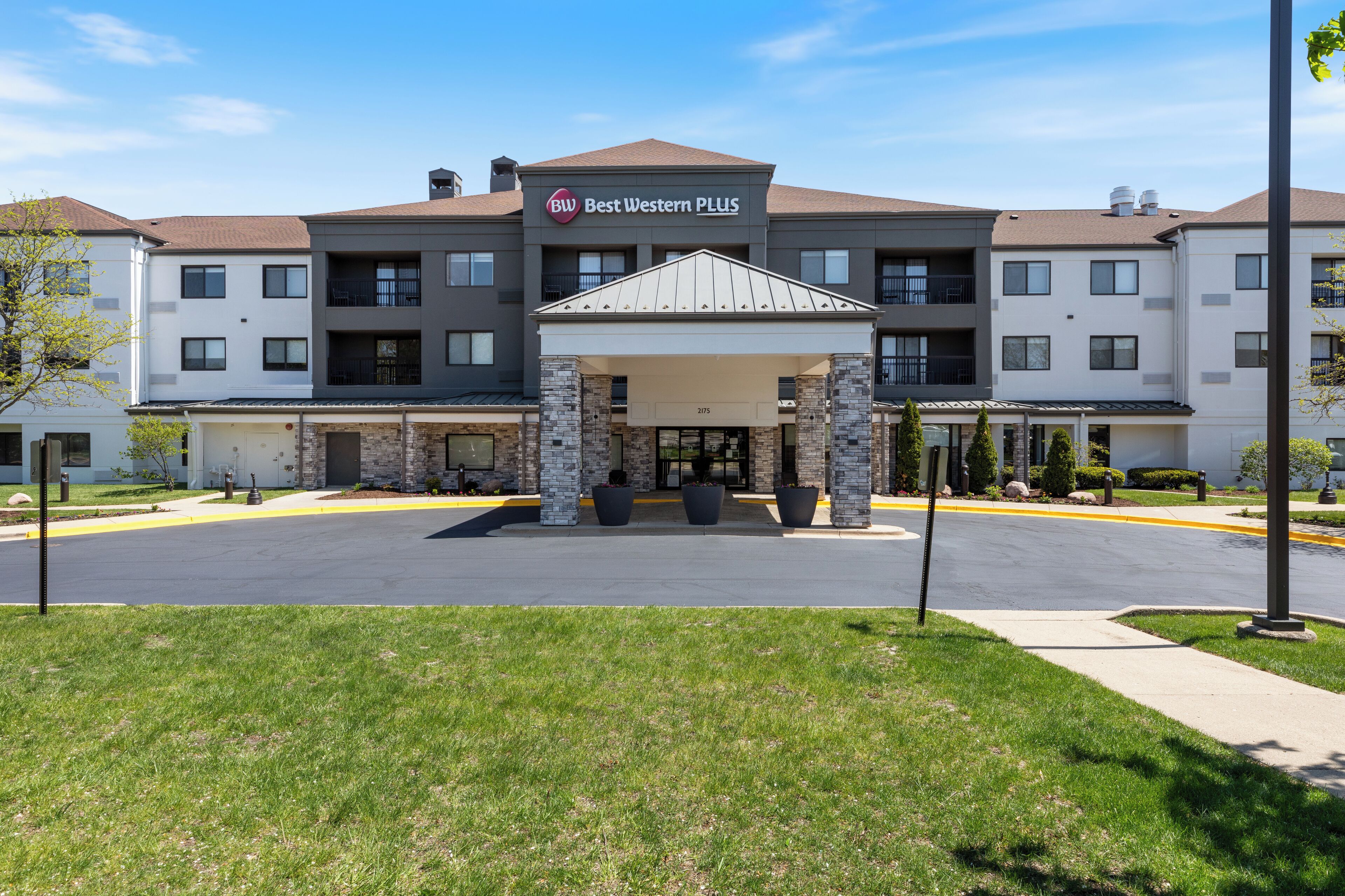 A Best Western PLUS hotel with a covered entrance, multiple floors, and a parking lot.
