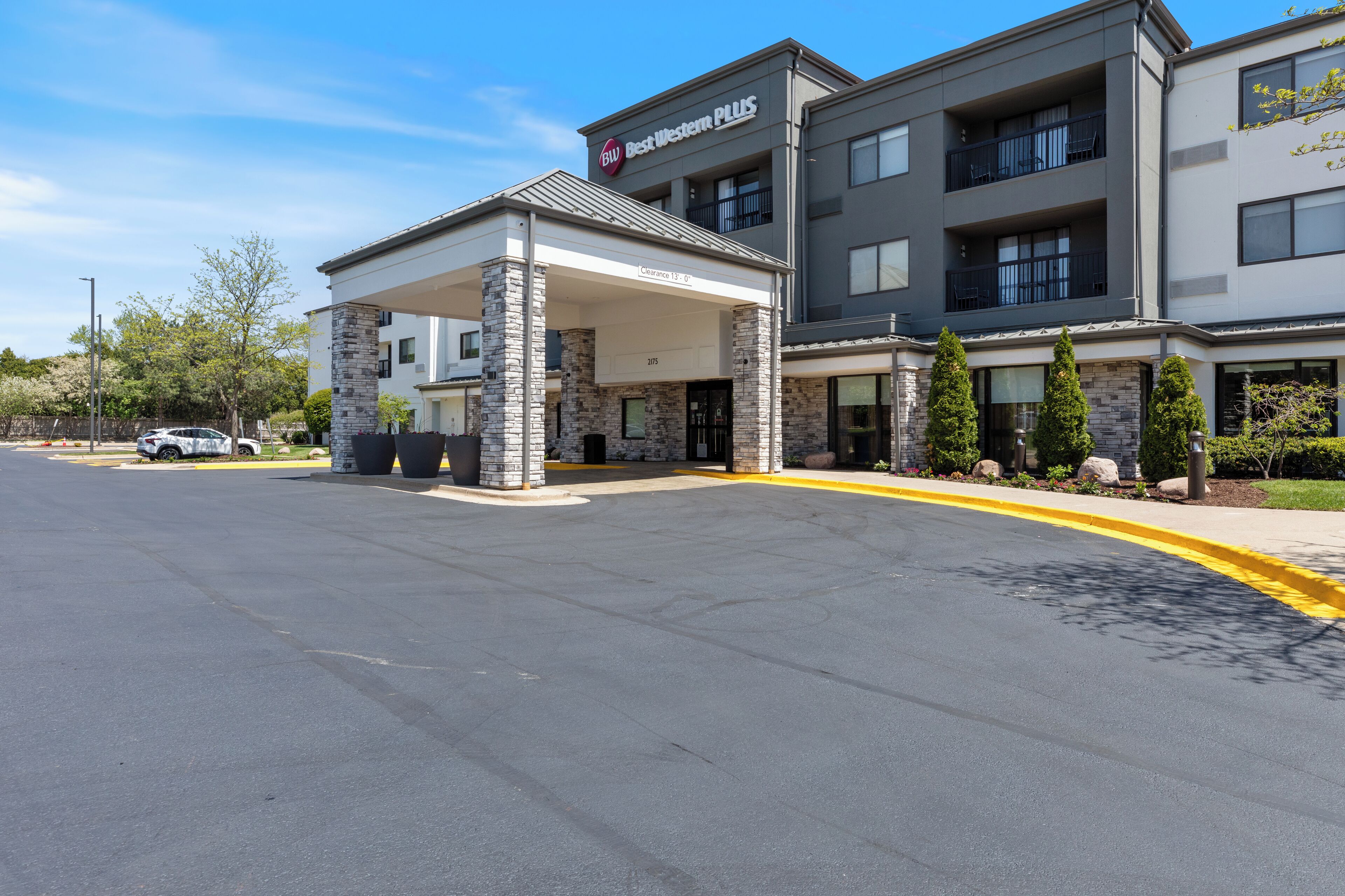 A Best Western Plus hotel with a covered entrance, stone facade, and multiple balconies.