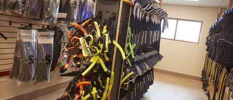 A store with rows of scuba diving gear, including masks and fins, on shelves and racks.