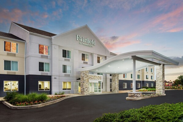 A Fairfield by Marriott hotel with a modern design, featuring a covered entrance and a landscaped driveway.