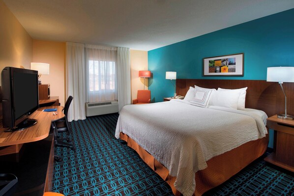 A hotel room with a bed, desk, television, and a window with curtains. - Fairfield Inn by Marriott Huntsville (Huntsville)