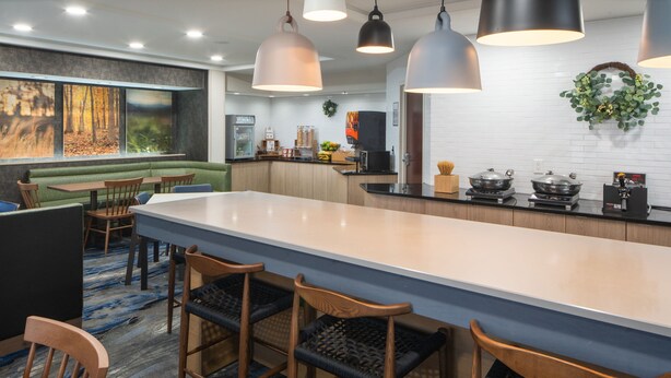 A modern kitchen with a central island, bar stools, and pendant lighting. - Fairfield Inn & Suites By Marriott Memphis Germantown (Germantown)