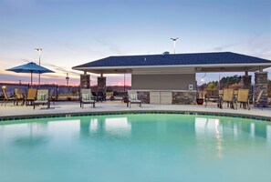 A swimming pool with lounge chairs and a covered seating area. - Holiday Inn Express Monticello by IHG (Monticello)