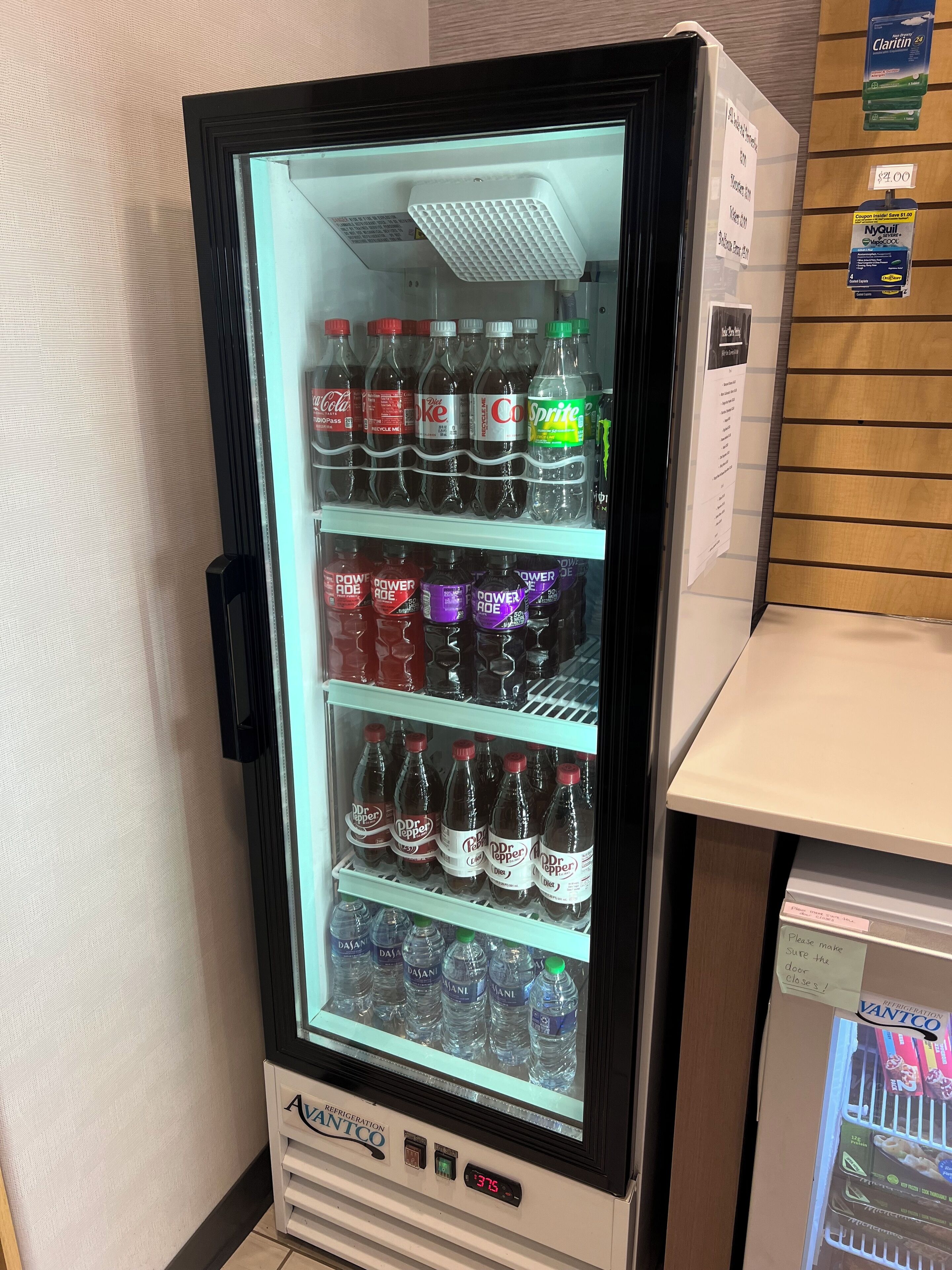 A vending machine stocked with various beverages including soda and water.