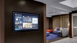 A GoBoard® display in a hotel lobby with a seating area in the background. - Courtyard Charleston Historic District (Charleston)