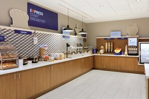 A breakfast area with a bakery section, hot food, cereal, and fruit display. - Holiday Inn Express Hotel & Suites Cleveland-Streetsboro by IHG (Streetsboro)
