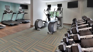 A gym with treadmills, elliptical machines, and free weights. - Holiday Inn Express Raleigh Durham Airport by IHG (Morrisville)
