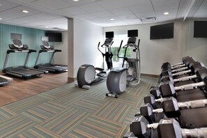 A gym with treadmills, elliptical machines, and free weights. - Holiday Inn Express Raleigh Durham Airport by IHG (Morrisville)